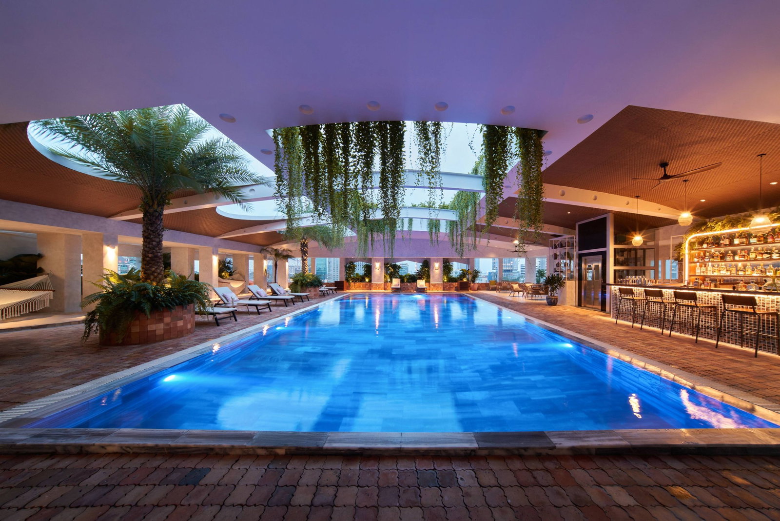 Maya Rooftop Pool Bar lit up in the evening