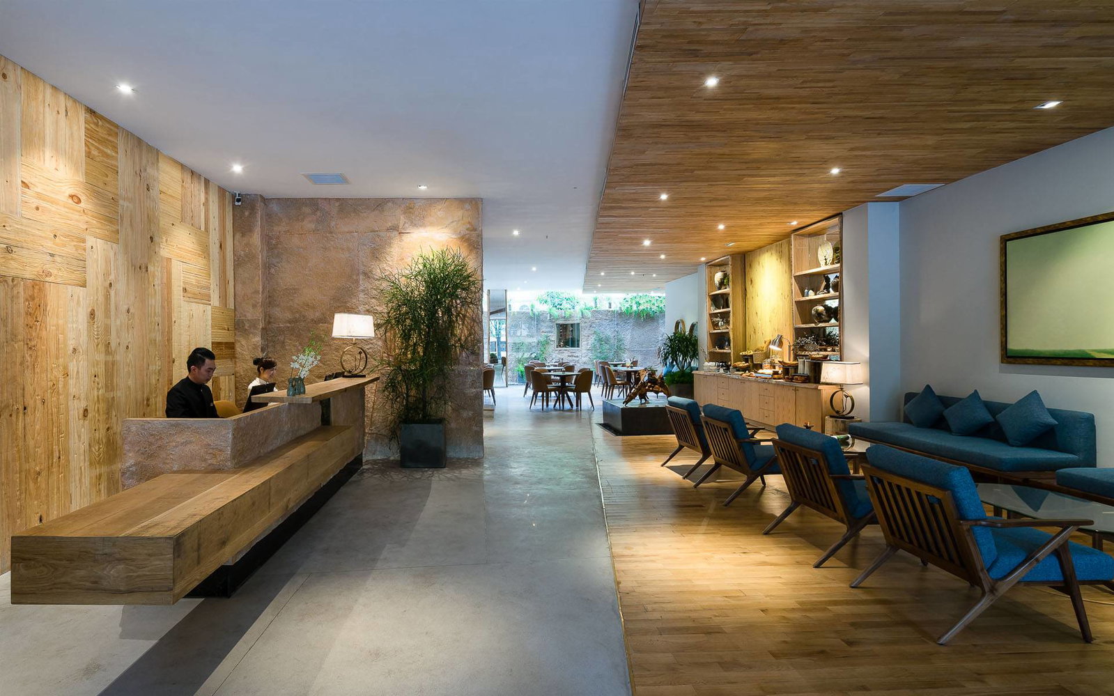Lobby of Silverland Yen, a cozy boutique hotel in Ho Chi Minh City, finished in raw wood and stone