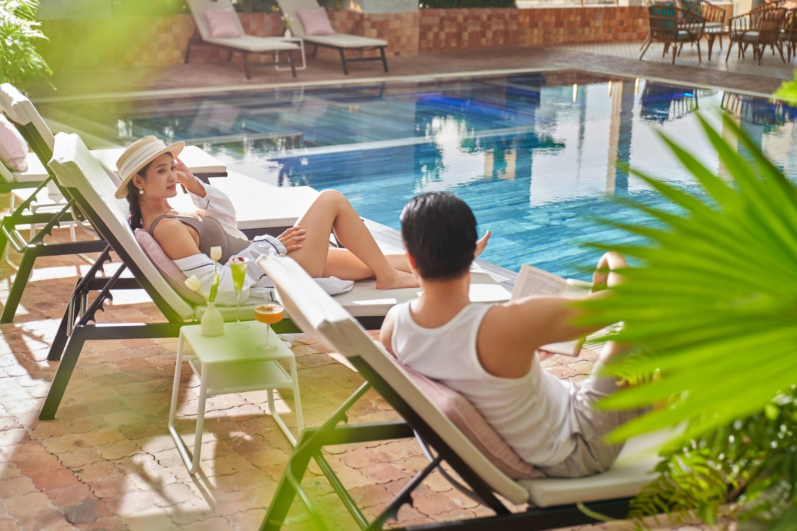 Guests relaxing poolside at Maya Rooftop Pool Bar on the 14th floor of Silverland Mây
