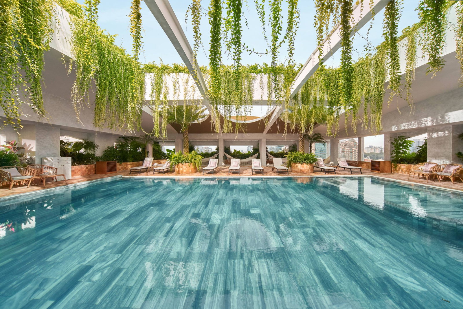 Maya Rooftop Pool Bar at Silverland Mây, a romantic boutique hotel in Ho Chi Minh City, with hanging greenery and city view