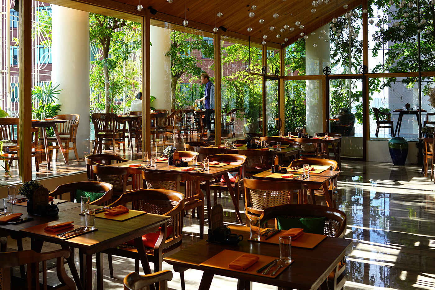 The Nest Restaurant glass-walled dining room with garden view at The Myst Dong Khoi