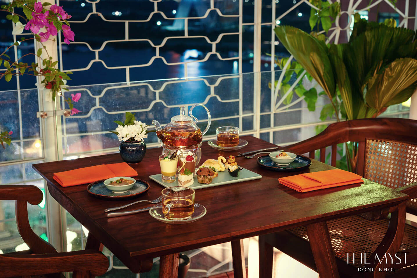 Window table set for afternoon tea at The Nest Restaurant, The Myst Dong Khoi, overlooking the Saigon River