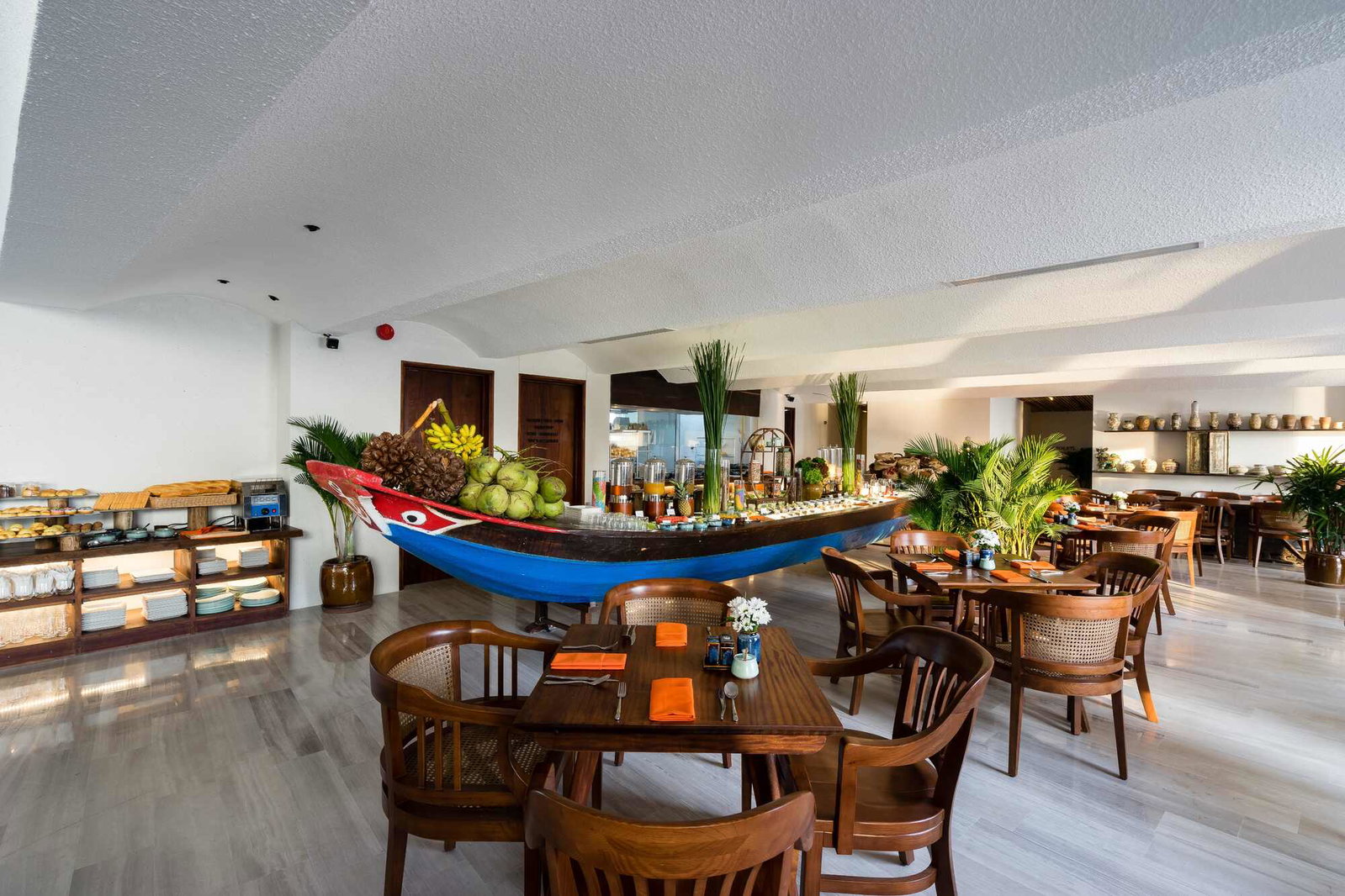 The wooden boat buffet spread in The Nest Restaurant dining room at The Myst Dong Khoi