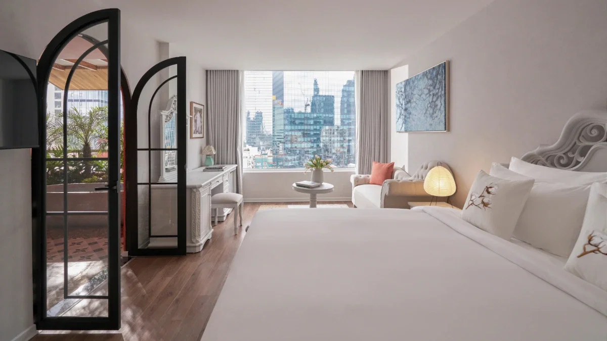 Why Are Silverland Mây's Rooms Named After Saigon's Flowers and Plants? 7 The Suite Double at Silverland Mây, arched French doors opening onto a private balcony over the District 1 skyline