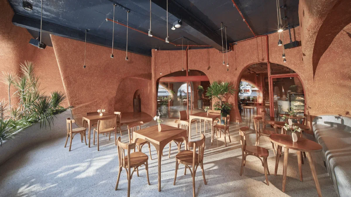 A Coffee Shop Steps From Ben Thanh Metro Station 2 Semi-outdoor seating with plants and natural light at Bason Café Ben Thanh near Ben Thanh Metro Station