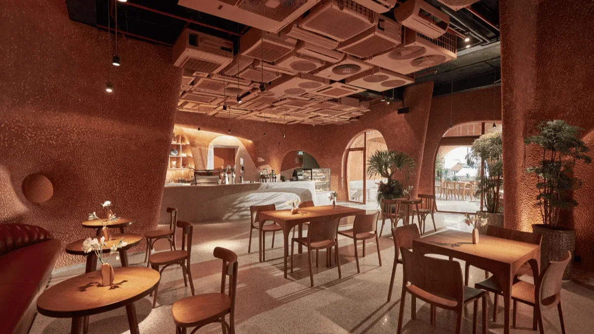 A Coffee Shop Steps From Ben Thanh Metro Station 1 Terracotta interior of Bason Café Ben Thanh, a coffee shop near Ben Thanh Metro Station, with a ceiling built from salvaged air conditioning units