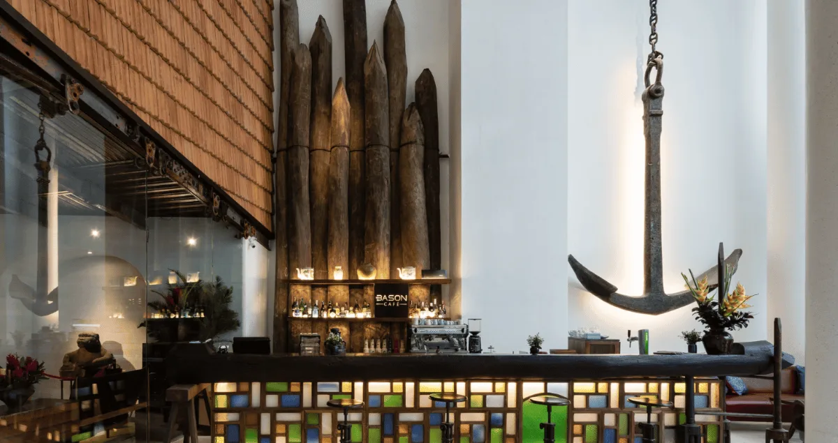Best Coffee Shops for a Business Meeting in District 1 6 The bar counter at Bason Café Dong Khoi with a large anchor hanging from the ceiling and wooden shipyard beams