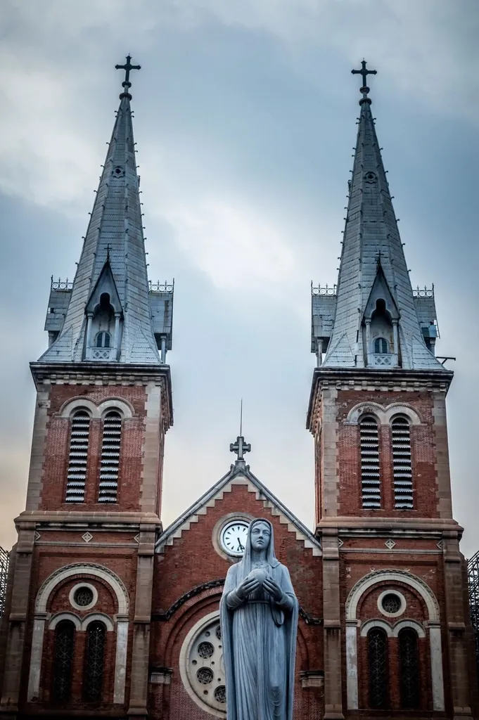 Notre-Dame Cathedral Basilica of Saigon, its twin bell towers and the Virgin Mary statue in front of the facade
